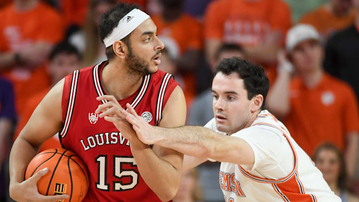 Louisville Cardinals center Aly Khalifa (15) is defended by Clemson Tigers forward Nick Davidson (11) Saturday, Feb. 28, 2026, during the NCAA men’s basketball game at Littlejohn Coliseum in Clemson, South Carolina. Clemson Tigers won 80-75.