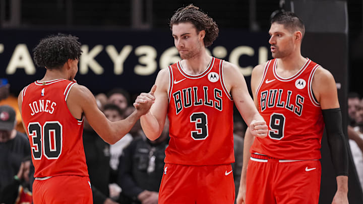 Dec 21, 2025; Atlanta, Georgia, USA; Chicago Bulls guard Tre Jones (30) guard Josh Giddey (3) and center Nikola Vucevic (9) react after defeating the Atlanta Hawks at State Farm Arena. Mandatory Credit: Dale Zanine-Imagn Images