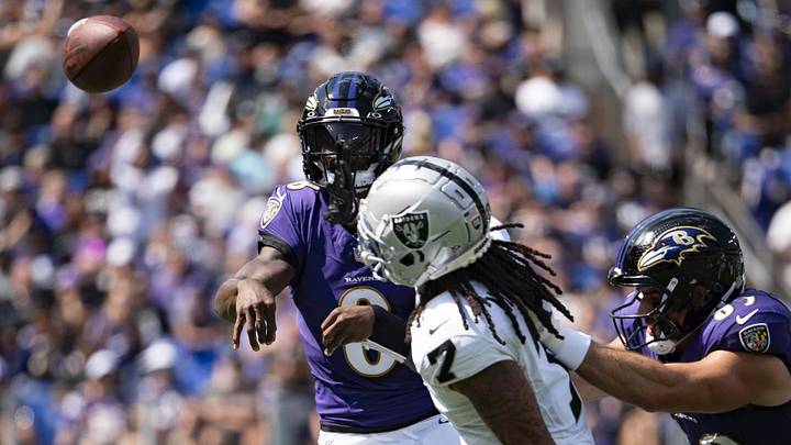 Sep 15, 2024; Baltimore, Maryland, USA;  Baltimore Ravens quarterback Lamar Jackson (8) throws over Las Vegas Raiders safety Tre'von Moehrig (7) during the  first half at M&T Bank Stadium. Mandatory Credit: Tommy Gilligan-Imagn Images