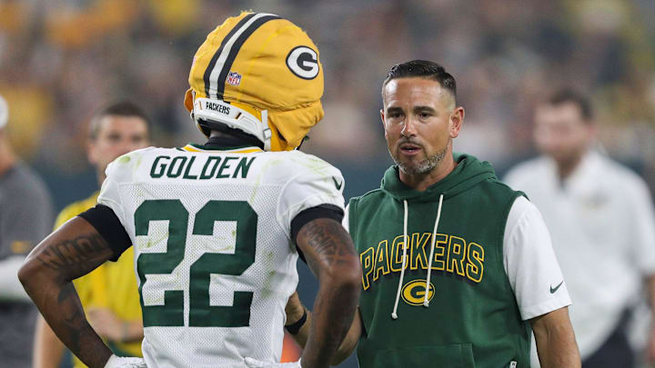 Green Bay Packers head coach Matt LaFleur talks to wide receiver Matthew Golden