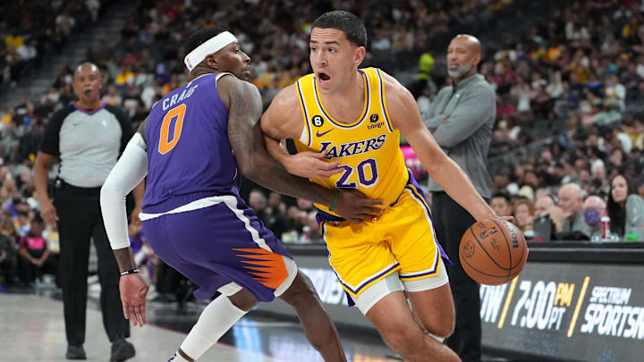 Oct 5, 2022; Las Vegas, Nevada, USA; Los Angeles Lakers forward Cole Swider (20) dribbles around Phoenix Suns forward Torrey Craig (0) during a preseason game at T-Mobile Arena. Mandatory Credit: Stephen R. Sylvanie-Imagn Images