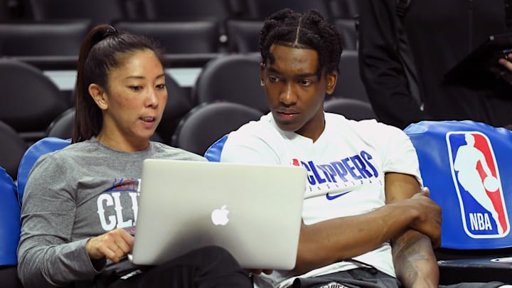 Los Angeles Clippers guard Terance Mann (right) talks with player development assistant coach Natalie Nakase before a game against the Philadelphia 76ers at Staples Center. Mandatory Credit: Jayne Kamin-Oncea-Imagn Images