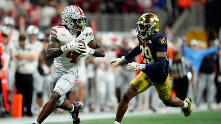 Ohio State Buckeyes wide receiver Jeremiah Smith (4) makes a catch against Notre Dame Fighting Irish cornerback Christian Gray (29) in the fourth quarter during the College Football Playoff National Championship at Mercedes-Benz Stadium in Atlanta on January 20, 2025.