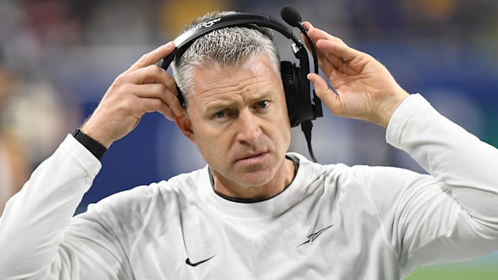 Dec 2, 2023; Detroit, MI, USA;  Toledo Rockets head coach Jason Candle puts on his head set before the MAC Championship game against the Miami RedHawks at Ford Field. Mandatory Credit: Lon Horwedel-Imagn Images