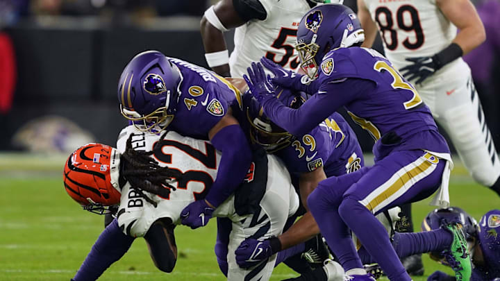 Nov 27, 2025; Baltimore, Maryland, USA; Baltimore Ravens linebacker Teddye Buchanan (40) tackles Cincinnati Bengals running back Gary Brightwell (32) during the first half at M&T Bank Stadium. Mandatory Credit: Mitch Stringer-Imagn Images