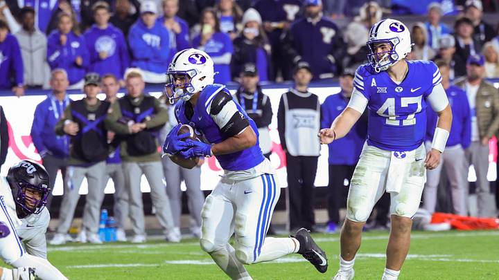 Nov 15, 2025; Provo, Utah, USA; BYU Cougars quarterback Bear Bachmeier (47) hands the ball off to running back LJ Martin (4) to score a touchdown against the Texas Christian University Horned Frogs during the fourth quarter at LaVell Edwards Stadium. Mandatory Credit: Rob Gray-Imagn Images