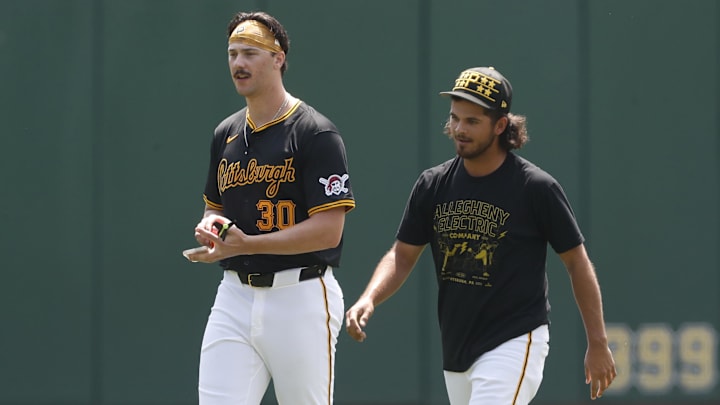 May 26, 2024; Pittsburgh, Pennsylvania, USA;  Pittsburgh Pirates pitchers Paul Skenes (left) and Jared Jones (right) walk in the outfield before the game against the Atlanta Braves at PNC Park. Mandatory Credit: Charles LeClaire-Imagn Images