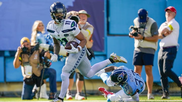Nov 23, 2025; Nashville, Tennessee, USA; Seattle Seahawks wide receiver Jaxon Smith-Njigba (11) receives a pass for a touchdown in front of Tennessee Titans safety Amani Hooker (37) during the second quarter at Nissan Stadium. 
