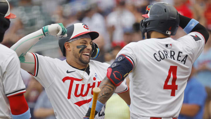 Jun 16, 2024; Minneapolis, Minnesota, USA; Minnesota Twins third baseman Royce Lewis (23) celebrates his three-run home run with shortstop Carlos Correa (4) against the Oakland Athletics in the first inning of game two of a double header at Target Field. Mandatory Credit: Bruce Kluckhohn-USA TODAY Sports