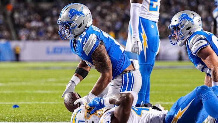 Detroit Lions running back Craig Reynolds (13) runs for a touchdown against LA Chargers safety Kendall Williamson (40) during the first half of the Hall of Fame Game at Tom Benson Hall of Fame Stadium in Canton, Ohio on Thursday, July 31, 2025.