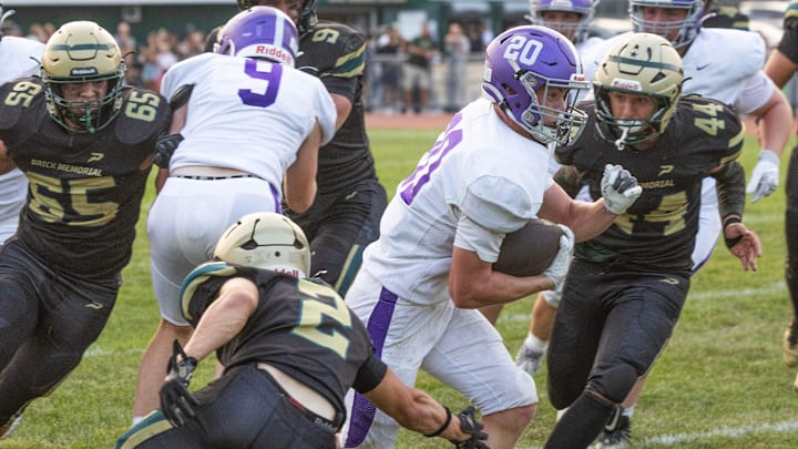 Rumson’s Ryder Izzo avoids two tacklers as he runs through the line. Rumson-Fair Haven football defeats Brick Memorial in Brick, NJ on September 5, 2025.