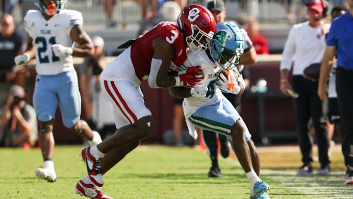 Sep 14, 2024; Norman, Oklahoma, USA;  Tulane Green Wave wide receiver Mario Williams (4) catches a pass as Oklahoma Sooners defensive back Robert Spears-Jennings (3) defends during the second half at Gaylord Family-Oklahoma Memorial Stadium.