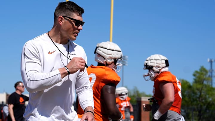 Oklahoma State offensive lineman coach Cooper Bassett runs drills during a Spring football practice at Oklahoma State University in Stillwater, Okla., Tuesday, April, 8, 2025.