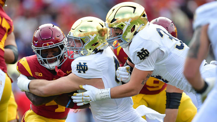 Nov 30, 2024; Los Angeles, California, USA; Southern California Trojans running back Woody Marks (4) is stopped by Notre Dame Fighting Irish defensive lineman Donovan Hinish (41) during the first half at the Los Angeles Memorial Coliseum. Mandatory Credit: Gary A. Vasquez-Imagn Images