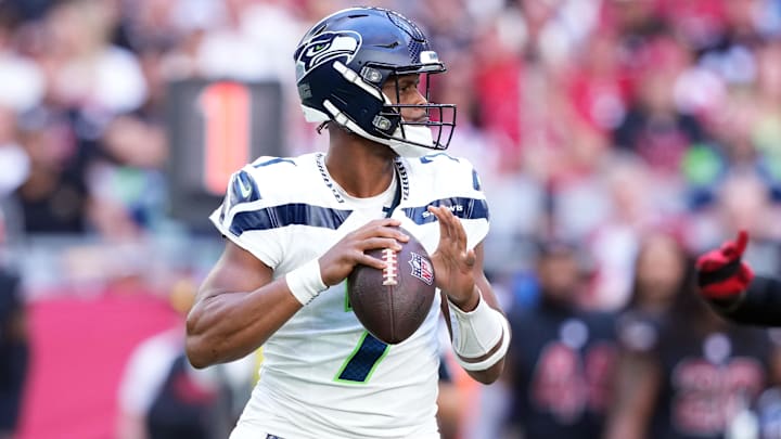 Dec 8, 2024; Glendale, Arizona, USA; Seattle Seahawks quarterback Geno Smith (7) passes against the Arizona Cardinals during the first half at State Farm Stadium. Mandatory Credit: Joe Camporeale-Imagn Images