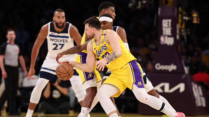 Apr 22, 2025; Los Angeles, California, USA; Los Angeles Lakers guard Luka Doncic (77) dribbles the ball against Minnesota Timberwolves forward Jaden McDaniels (3) during the first quarter of game two of first round for the 2024 NBA Playoffs at Crypto.com Arena.