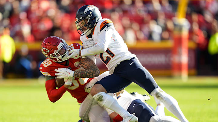 Nov 10, 2024; Kansas City, Missouri, USA; Kansas City Chiefs tight end Peyton Hendershot (88) is tackled by Denver Broncos cornerback Riley Moss (21) during the second half at GEHA Field at Arrowhead Stadium. Mandatory Credit: Jay Biggerstaff-Imagn Images
