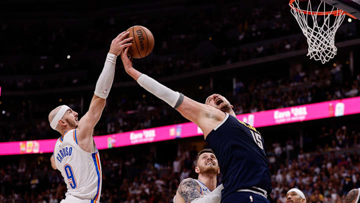 May 11, 2025; Denver, Colorado, USA; Oklahoma City Thunder guard Alex Caruso (9) and Denver Nuggets center Nikola Jokic (15) battle for a rebound as center Isaiah Hartenstein (55) defends in the fourth quarter during game four of the second round of the 2025 NBA Playoffs at Ball Arena. Mandatory Credit: Isaiah J. Downing-Imagn Images
