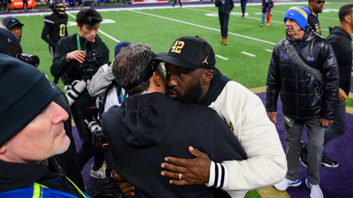 Nov 15, 2024; Seattle, Washington, USA; Washington Huskies head coach Jedd Fisch and UCLA Bruins head coach DeShaun Foster greet each other after the game at Alaska Airlines Field at Husky Stadium. Mandatory Credit: Steven Bisig-Imagn Images