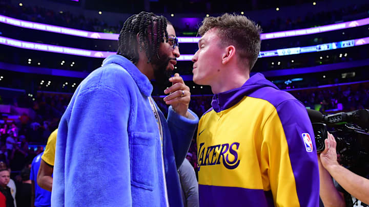 Feb 25, 2025; Los Angeles, California, USA; Dallas Mavericks forward Anthony Davis (left) reacts with Los Angeles Lakers guard Dalton Knecht (right) after the game at Crypto.com Arena. Mandatory Credit: Gary A. Vasquez-Imagn Images