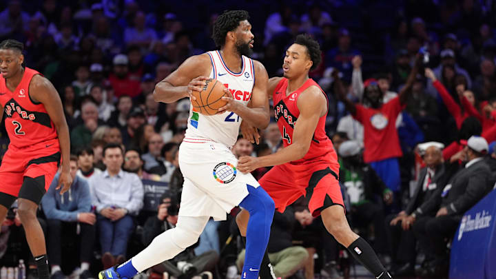 Feb 11, 2025; Philadelphia, Pennsylvania, USA; Philadelphia 76ers center Joel Embiid (21) drives against Toronto Raptors forward Scottie Barnes (4) in the fourth quarter at Wells Fargo Center. Mandatory Credit: Kyle Ross-Imagn Images
