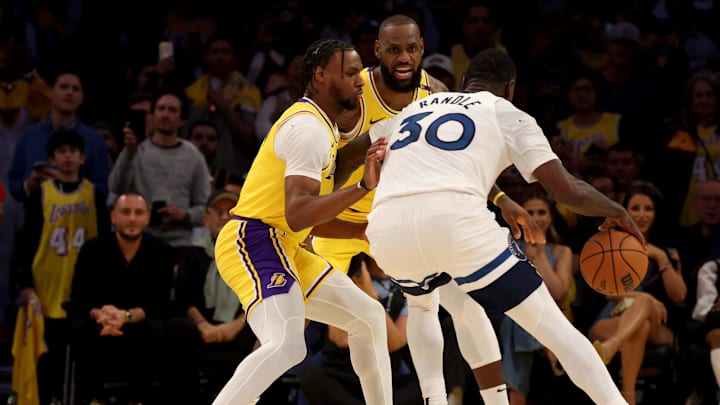Oct 22, 2024; Los Angeles, California, USA; Los Angeles Lakers guard Bronny James (9) and forward LeBron James (23) guard Minnesota Timberwolves forward Julius Randle (30) during the second quarter against the Minnesota Timberwolves at Crypto.com Arena. This marked the first time in NBA history that a father and son played together. Mandatory Credit: Jason Parkhurst-Imagn Images Oct 22, 2024; Los Angeles, California, USA; Los Angeles Lakers guard Bronny James (9) and forward LeBron James (23) guard Minnesota Timberwolves forward Julius Randle (30) during the second quarter against the Minnesota Timberwolves at Crypto.com Arena. This marked the first time in NBA history that a father and son played together. Mandatory Credit: Jason Parkhurst-Imagn Images