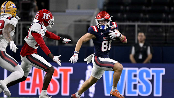 Jan 30, 2025; Arlington, TX, USA; East wide receiver Efton Chism of Eastern Washington (81) eludes West defensive back Robert Longerbeam of Rutgers (20) during the first half at AT&T Stadium.