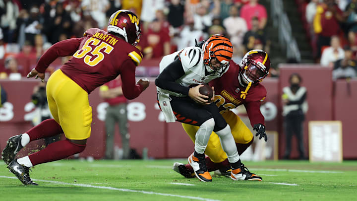 Aug 18, 2025; Landover, Maryland, USA; Cincinnati Bengals quarterback Joe Burrow (9) is sacked by Washington Commanders defensive end Dorance Armstrong (92) and Washington Commanders defensive end Jacob Martin (55) during the first half at Northwest Stadium. Mandatory Credit: Amber Searls-Imagn Images