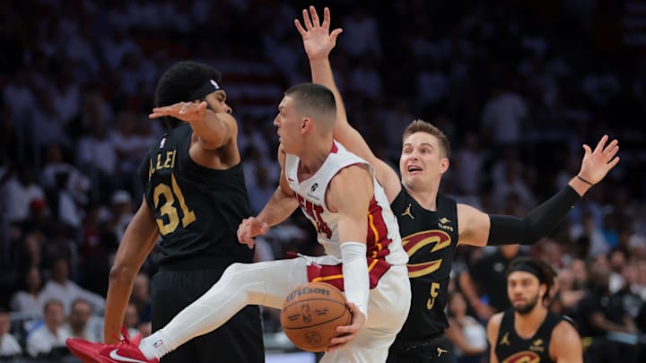 Apr 28, 2025; Miami, Florida, USA; Miami Heat guard Tyler Herro (14) passes the basketball as Cleveland Cavaliers center Jarrett Allen (31) and guard Sam Merrill (5) defend in the first quarter during game four for the first round of the 2025 NBA Playoffs at Kaseya Center. Mandatory Credit: Sam Navarro-Imagn Images Apr 28, 2025; Miami, Florida, USA; Miami Heat guard Tyler Herro (14) passes the basketball as Cleveland Cavaliers center Jarrett Allen (31) and guard Sam Merrill (5) defend in the first quarter during game four for the first round of the 2025 NBA Playoffs at Kaseya Center. Mandatory Credit: Sam Navarro-Imagn Images