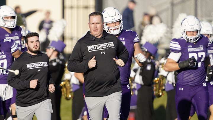 Nov 26, 2022; Evanston, Illinois, USA; Northwestern Wildcats head coach Pat Fitzgerald leads his team on the field against the Illinois Fighting Illini at Ryan Field. Mandatory Credit: David Banks-Imagn Images