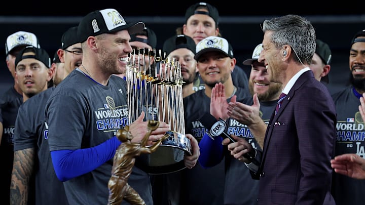 Oct 31, 2024; New York, New York, USA; Los Angeles Dodgers first baseman Freddie Freeman (5) celebrates with the Commissioner’s Trophy after the Los Angeles Dodgers beat the New York Yankees in game four to win the 2024 MLB World Series at Yankee Stadium. Mandatory Credit: Brad Penner-Imagn Images