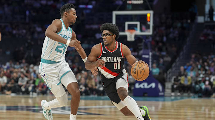 Apr 3, 2024; Charlotte, North Carolina, USA; Portland Trail Blazers guard Scoot Henderson (00) drives to the basket against Charlotte Hornets forward Brandon Miller (24) during the first quarter at Spectrum Center. Mandatory Credit: Jim Dedmon-Imagn Images
