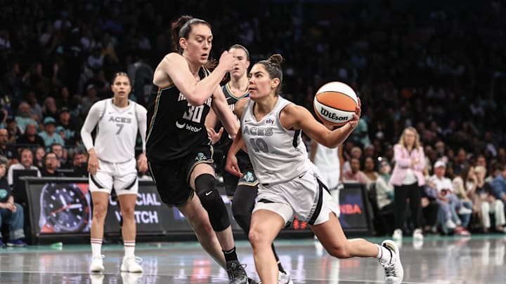 Oct 1, 2024; Brooklyn, New York, USA; Las Vegas Aces guard Kelsey Plum (10) drives past New York Liberty forward Breanna Stewart (30) during game two of the 2024 WNBA Semi-finals at Barclays Center. Mandatory Credit: Wendell Cruz-Imagn Images