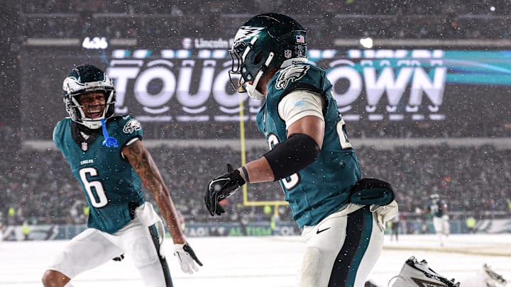 Jan 19, 2025; Philadelphia, Pennsylvania, USA; Philadelphia Eagles running back Saquon Barkley (26) celebrates alongside wide receiver DeVonta Smith (6) after his touchdown run during the fourth quarter against the Los Angeles Rams in a 2025 NFC divisional round game at Lincoln Financial Field. Mandatory Credit: Bill Streicher-Imagn Images