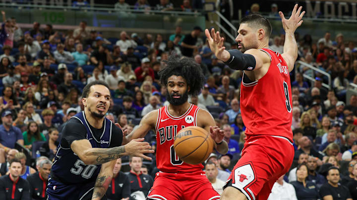 Apr 7, 2024; Orlando, Florida, USA; Orlando Magic guard Cole Anthony (50) passes the ball around Chicago Bulls guard Coby White (0) and center Nikola Vucevic (9) during the second quarter at KIA Center. Mandatory Credit: Mike Watters-Imagn Images Apr 7, 2024; Orlando, Florida, USA; Orlando Magic guard Cole Anthony (50) passes the ball around Chicago Bulls guard Coby White (0) and center Nikola Vucevic (9) during the second quarter at KIA Center. Mandatory Credit: Mike Watters-Imagn Images
