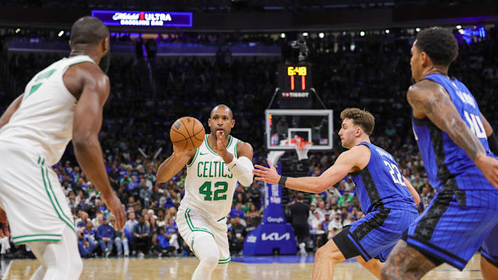 Apr 25, 2025; Orlando, Florida, USA; Boston Celtics center Al Horford (42) passes the ball against Orlando Magic forward Franz Wagner (22) during the second half of game three of first round for the 2024 NBA Playoffs at Kia Center. Mandatory Credit: Mike Watters-Imagn Images