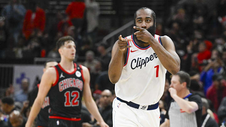 Feb 26, 2025; Chicago, Illinois, USA;  LA Clippers guard James Harden (1) points towards former Chicago Bulls player Pat Beverley, who was on the sidelines, after scoring against the Chicago Bulls during the second half at the United Center. Mandatory Credit: Matt Marton-Imagn Images