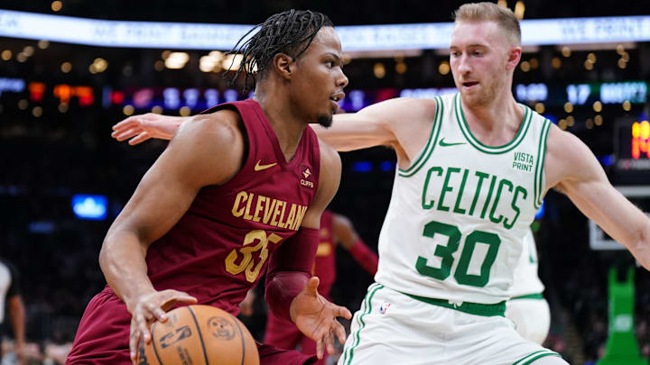 Dec 12, 2023; Boston, Massachusetts, USA;  Cleveland Cavaliers forward Isaac Okoro (35) drives the ball against Boston Celtics forward Sam Hauser (30) in the first quarter at TD Garden. Mandatory Credit: David Butler II-Imagn Images