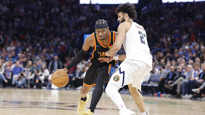 Mar 9, 2025; Oklahoma City, Oklahoma, USA; Oklahoma City Thunder guard Shai Gilgeous-Alexander (2) drives to the basket against Denver Nuggets guard Jamal Murray (27) during the second half at Paycom Center. Mandatory Credit: Alonzo Adams-Imagn Images