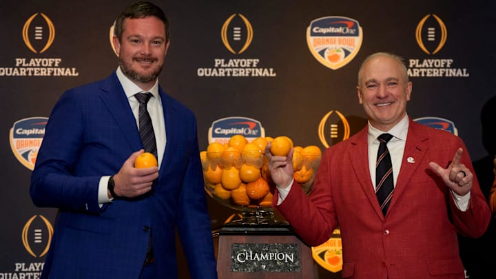 Oregon head coach Dan Lanning, left, and Texas Tech head coach Joey McGuire with the Orange Bowl trophy during the head coaches press conference ahead of Orange Bowl on Dec. 31, 2025, in Dania Beach, Florida. Oregon head coach Dan Lanning, left, and Texas Tech head coach Joey McGuire with the Orange Bowl trophy during the head coaches press conference ahead of Orange Bowl on Dec. 31, 2025, in Dania Beach, Florida.
