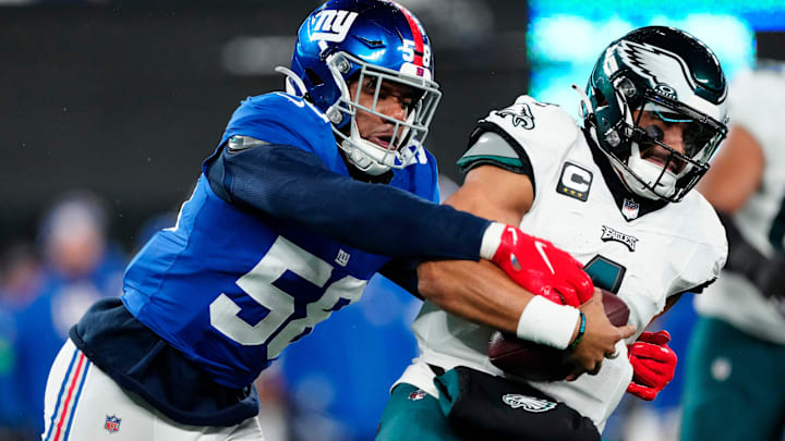 New York Giants linebacker Bobby Okereke (58) goes after Philadelphia Eagles quarterback Jalen Hurts (1) just before sacking him in the second quarter, Sunday, January 7, 2024.