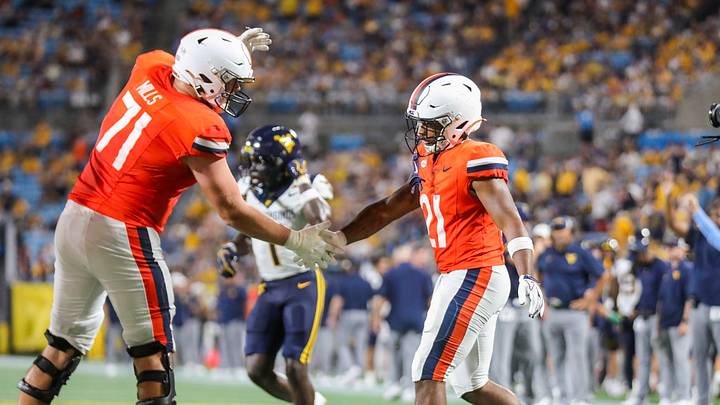 Sep 19, 2026; Charlotte, North Carolina, USA; Virginia Cavaliers running back Jekail Middlebrook (21) celebrates with Virginia Cavaliers offensive lineman Monroe Mills (71) after scoring a touchdown during the third quarter against the West Virginia Mountaineers at Bank of America Stadium. Mandatory Credit: Ben Queen-Imagn Images Sep 19, 2026; Charlotte, North Carolina, USA; Virginia Cavaliers running back Jekail Middlebrook (21) celebrates with Virginia Cavaliers offensive lineman Monroe Mills (71) after scoring a touchdown during the third quarter against the West Virginia Mountaineers at Bank of America Stadium. Mandatory Credit: Ben Queen-Imagn Images