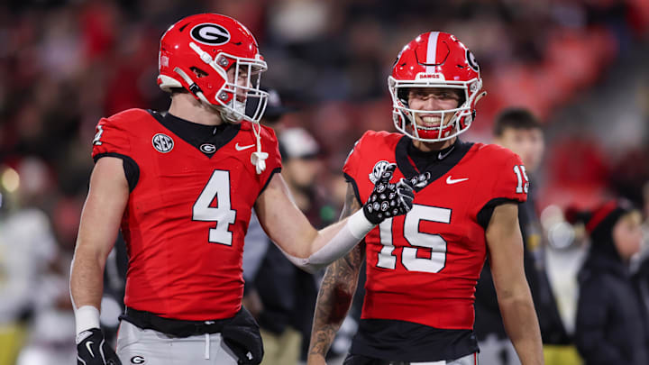 Nov 29, 2024; Athens, Georgia, USA; Georgia Bulldogs tight end Oscar Delp (4) and quarterback Carson Beck (15) prepare for a game against the Georgia Tech Yellow Jackets at Sanford Stadium. Mandatory Credit: Brett Davis-Imagn Images
