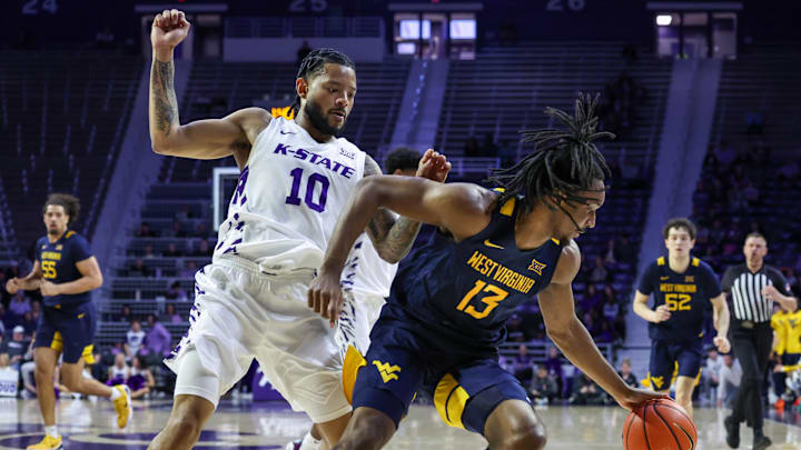 Mar 3, 2026; Manhattan, Kansas, USA; West Virginia Mountaineers guard Chance Moore (13) is guarded by Kansas State Wildcats guard David Castillo (10) during the first half at Bramlage Coliseum. 