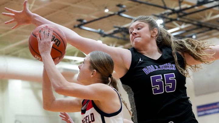 Brownsburg's Avery Gordon (55) guards Plainfield's Ellie Stewart (1) as she shoots the ball 