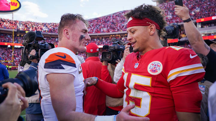 Nov 10, 2024; Kansas City, Missouri, USA; Denver Broncos quarterback Bo Nix (10) talks with Kansas City Chiefs quarterback Patrick Mahomes (15) after the game at GEHA Field at Arrowhead Stadium. Mandatory Credit: Denny Medley-Imagn Images