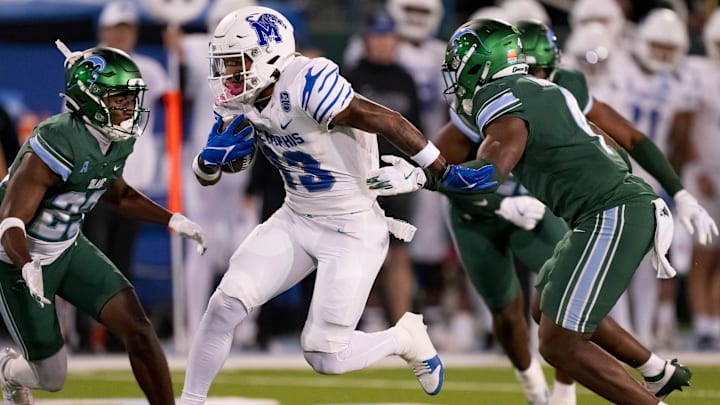 Nov 28, 2024; New Orleans, Louisiana, USA; Memphis Tigers running back Greg Desrosiers Jr. (13) breaks away from Tulane Green Wave linebacker Chris Rodgers (4) finishing off the play with a touchdown during the second quarter at Yulman Stadium Nov 28, 2024; New Orleans, Louisiana, USA; Memphis Tigers running back Greg Desrosiers Jr. (13) breaks away from Tulane Green Wave linebacker Chris Rodgers (4) finishing off the play with a touchdown during the second quarter at Yulman Stadium
