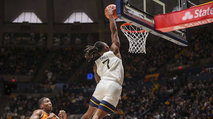 Jan 4, 2025; Morgantown, West Virginia, USA; West Virginia Mountaineers guard Javon Small (7) dunks the ball during the first half against the Oklahoma State Cowboys at WVU Coliseum. Mandatory Credit: Ben Queen-Imagn Images