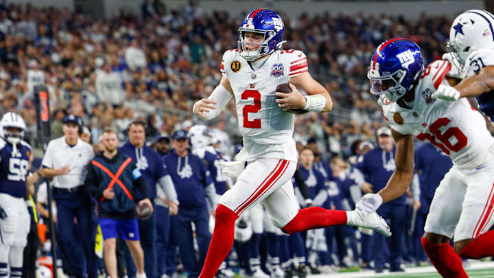 Nov 28, 2024; Arlington, Texas, USA;  New York Giants quarterback Drew Lock (2) rushes with the ball during the first quarter against the Dallas Cowboys at AT&T Stadium.  