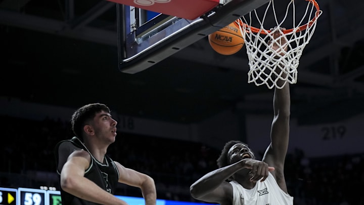 Nov 26, 2025; Cincinnati, Ohio, USA;  Cincinnati Bearcats center Moustapha Thiam (52) misses a dunk against Eastern Michigan Eagles forward Mohammad Habhab (4) in the second half at Fifth Third Arena. Mandatory Credit: Aaron Doster-Imagn Images